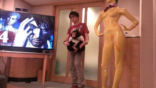 Here's Swery holding a monkey and standing next to a yellow plastic woman